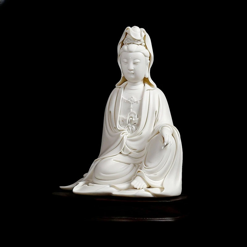Ceramic Guanyin statue white porcelain carving artwork sits on Guanyin