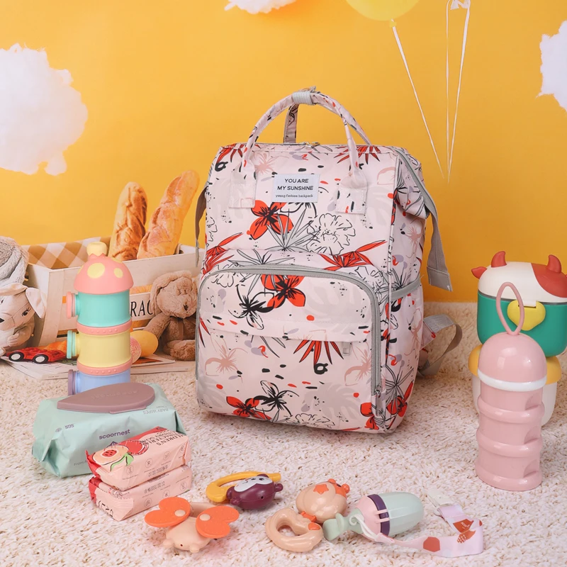 A lady pink orchid white peach pattern fashion trend mother and baby bag, suitable for daily use with children out