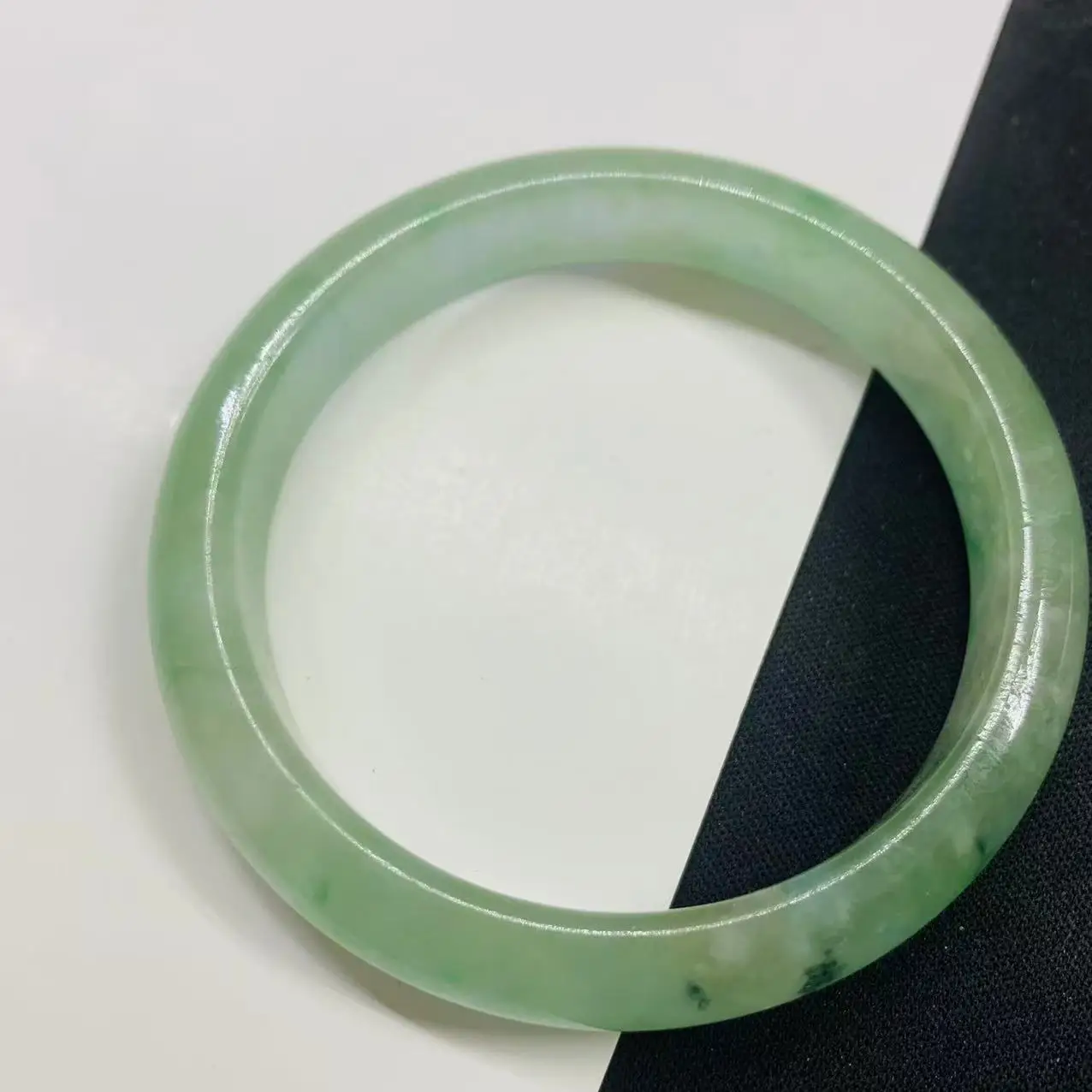 

Light green 56.3mm jadeite green flower jade bracelet photographed in real life