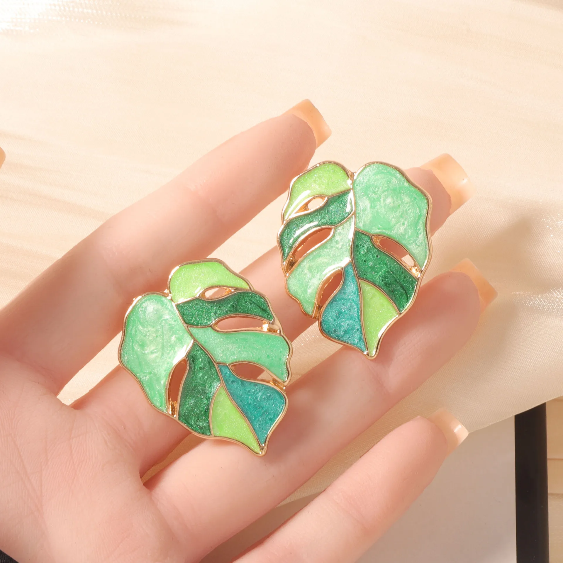 Mori temperament light luxury niche creative design drip oil alloy hollow leaves dream color stud earrings