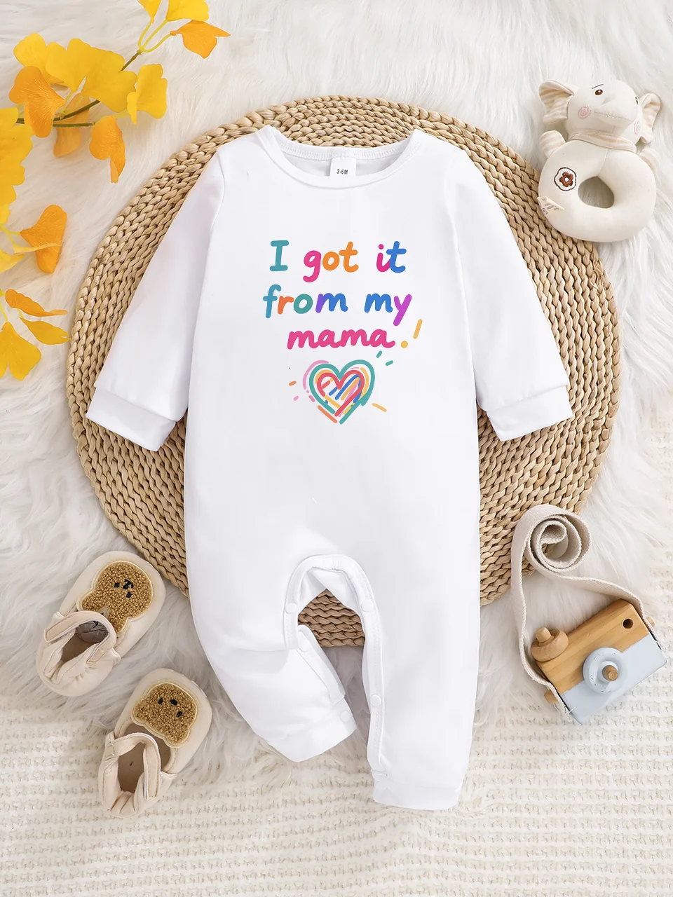 A baby long-sleeved onesie with interesting letter prints. It features a buttoned design for easy putting on and taking off