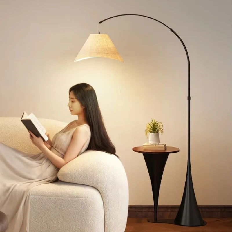 Retro-style floor lamp with fishing lamp next to it, with living room sofa, coffee table and bedside table.
