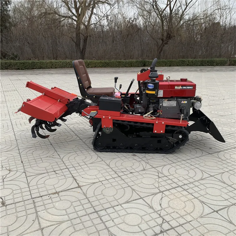 Household small agricultural rotary tiller rides on tracks with engine core for hard and clay trenching