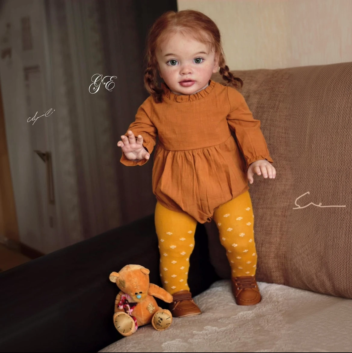 

26'' Reborn Baby Doll Pippa in Long Sleeve Caramel Footed Romper - Lifelike with Flowing Rooted Hair & Expressive Sweet Face