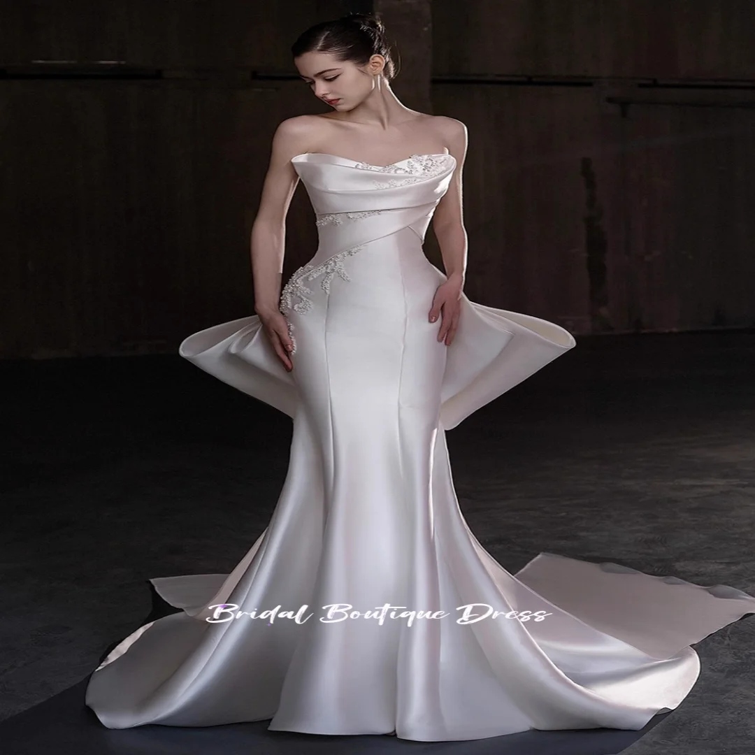 Vestidos de novia sin mangas de satén con cuentas y escote en forma de corazón personalizados, vestido de fiesta de princesa con lazo grande en la espalda