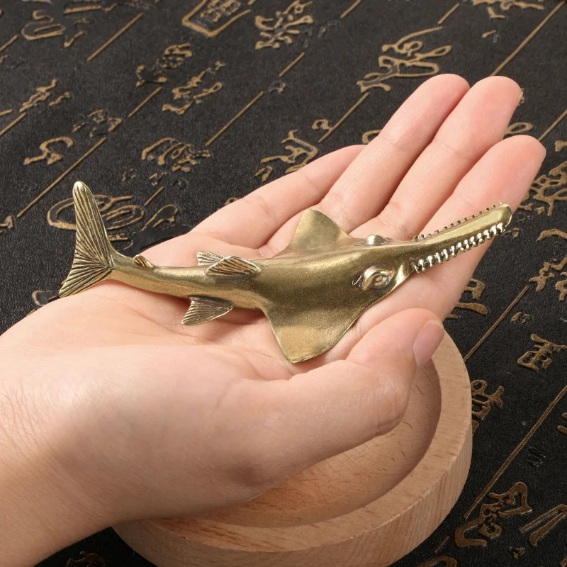 

Deep-sea shark sawfish brass figurine, antique-style decoration imitating antique and vintage objects.