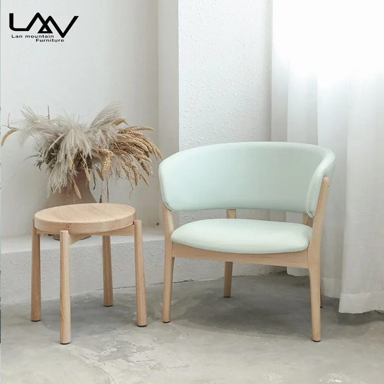 

Modern wood-framed leather-upholstered lounge chair with armrests for living rooms and hotel bedrooms