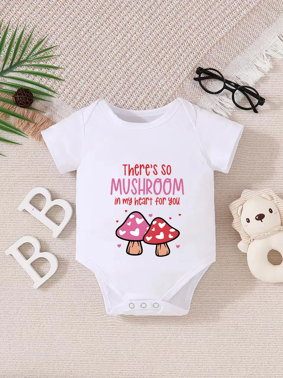 Playful letter-printed baby short-sleeve triangle bodysuit. Button closure for easy dressing, machine washable