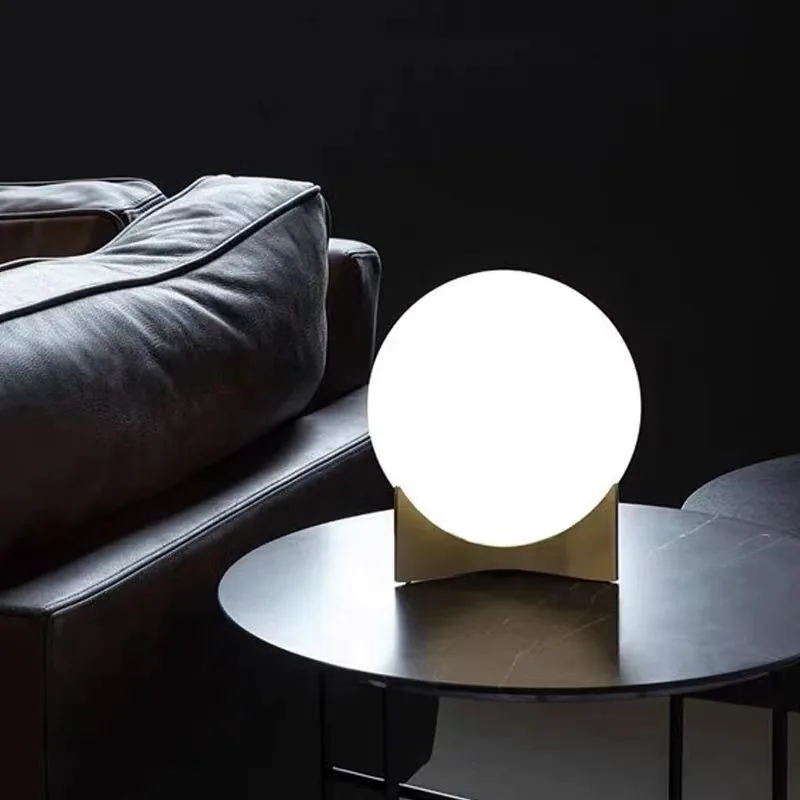 Lighting hotel bedroom bedside sofa next to metal glass ball table lamp