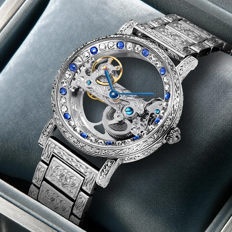 

A men's business-casual style mechanical watch with colorful diamond cutouts, silver case, and silver steel band