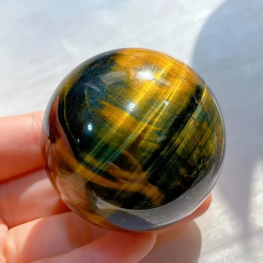 Natural Crystal Ball with Cat'S Eye Effect in Blue And Yellow Tiger Eye Stone, Featuring Blue And Yellow Patterns Feng Shui