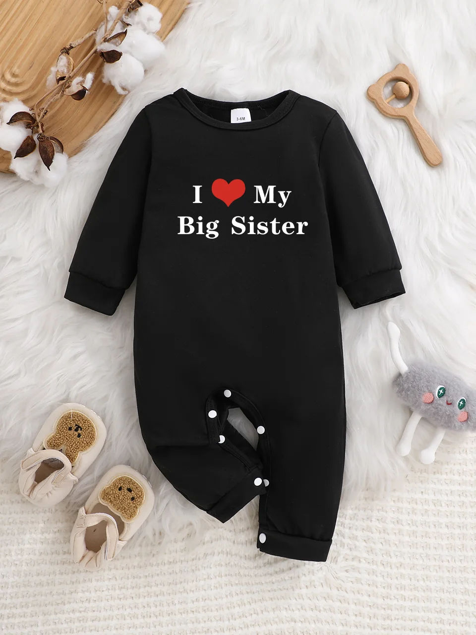 A baby long-sleeved onesie with interesting letter prints. It features a buttoned design for easy putting on and taking off