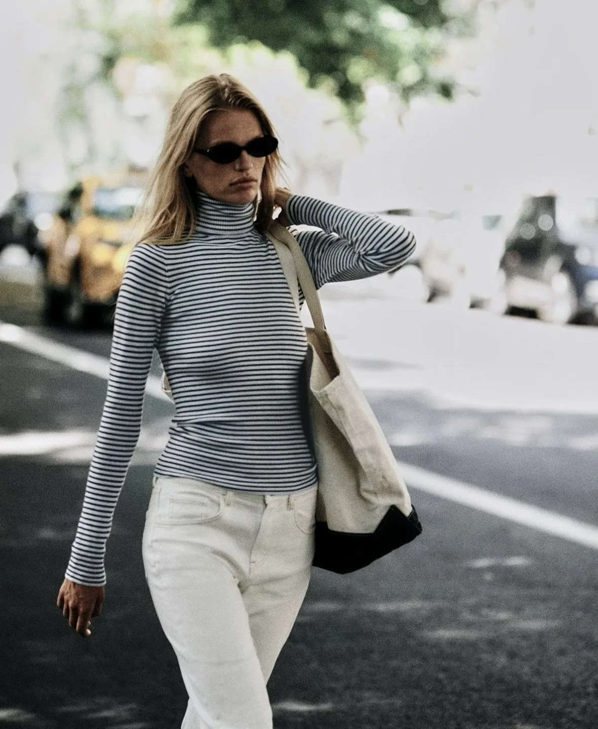 Frankies slim knit in blue and white stripes with turtleneck bottoms on the shoulders for a slimming look