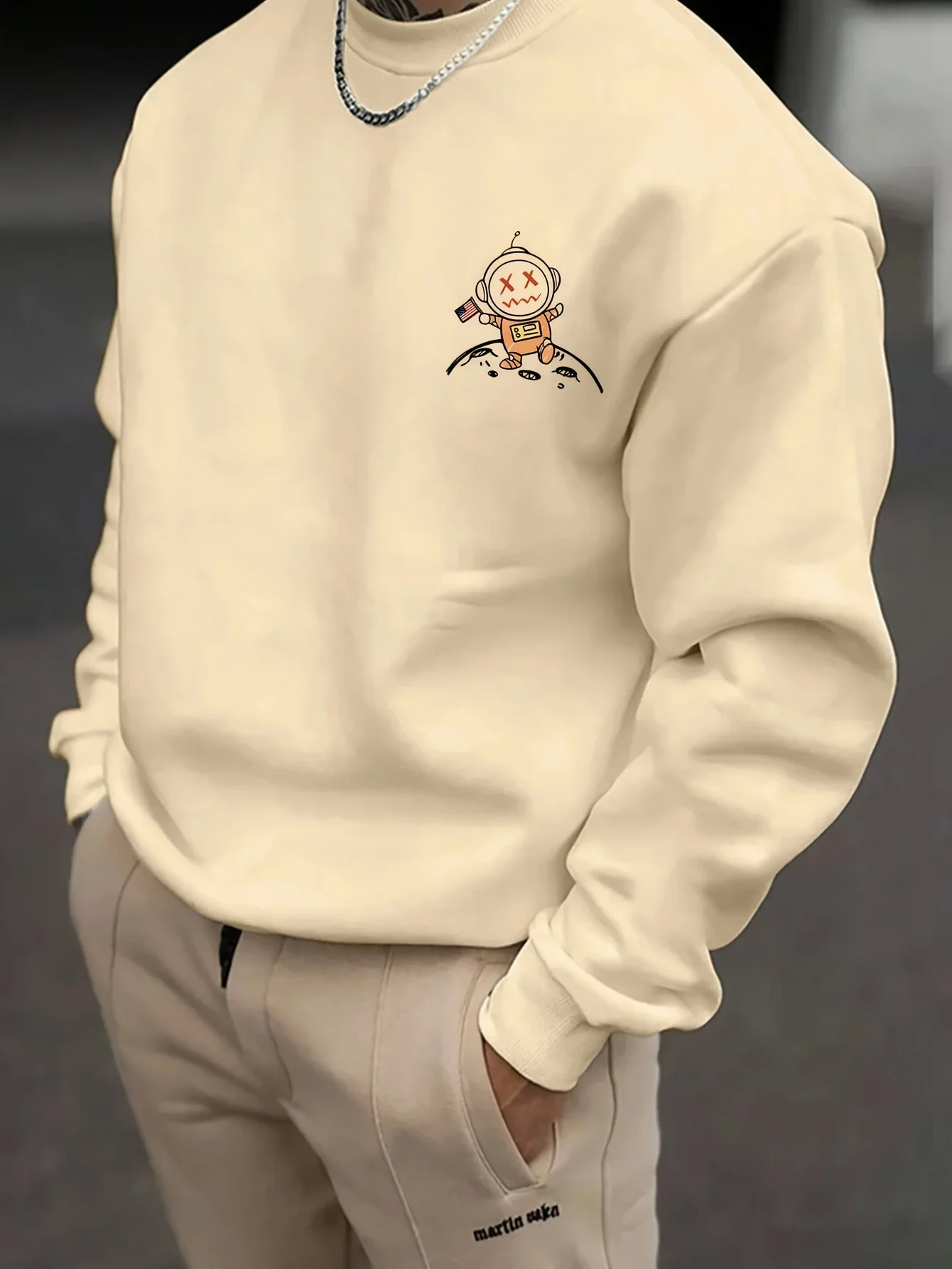 Herren-Sweatshirt mit Rundhalsausschnitt, langärmeliges Pullover-Modell mit Cartoon-Astronauten- und Planetenmuster, lässiger Streetwear-Sweatshirt mit lockerer Passform. – Detail 3