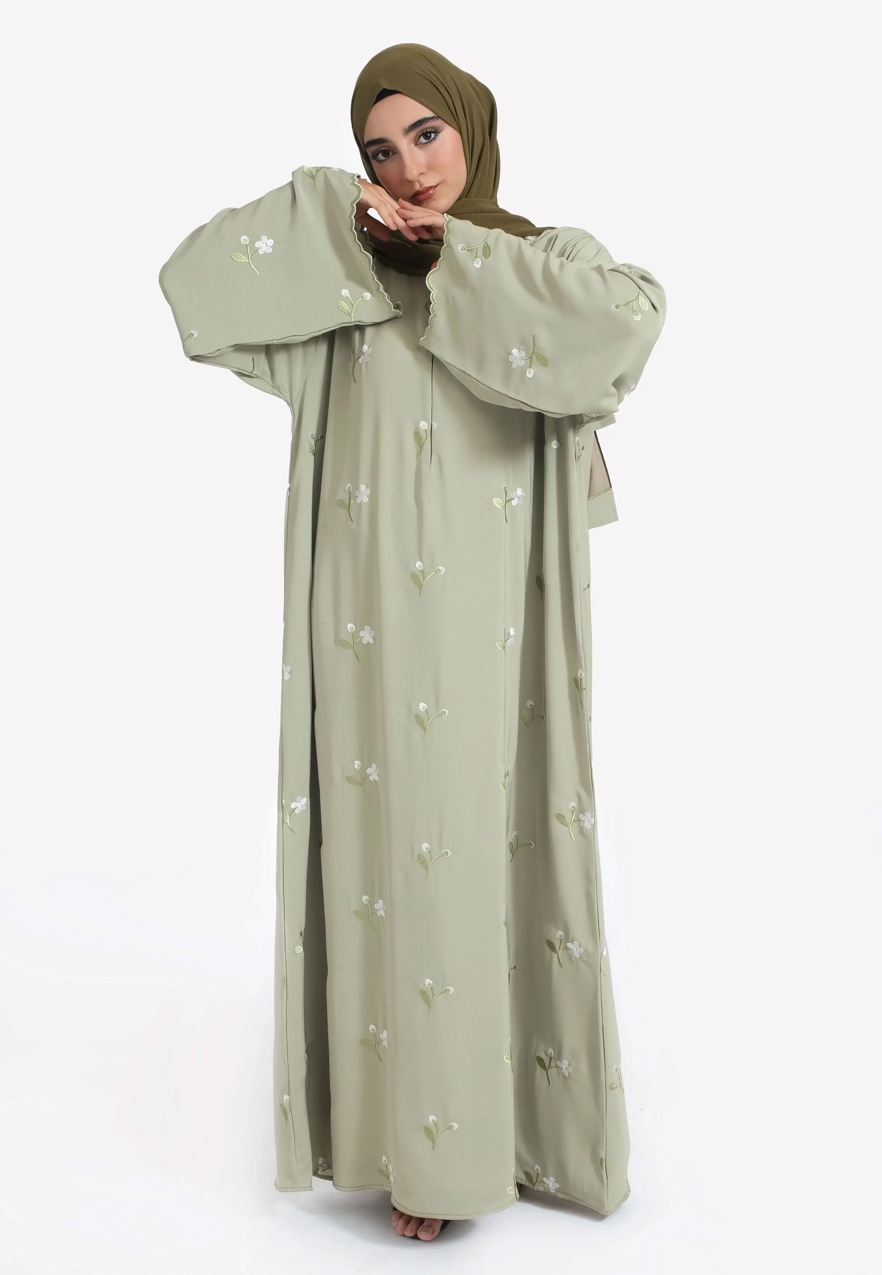

Light Olive Green Abaya with White Floral Embroidery Flared Sleeves and Delicate Trim for Elegant Fashion in the Middle East
