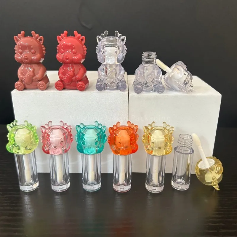 

50Pcs Wholesale Custom Logo Unique Cosmetic Packaging Container 2 ml Cute Cartoon Dragon Top Clear Mini Lip Gloss Brush Tube