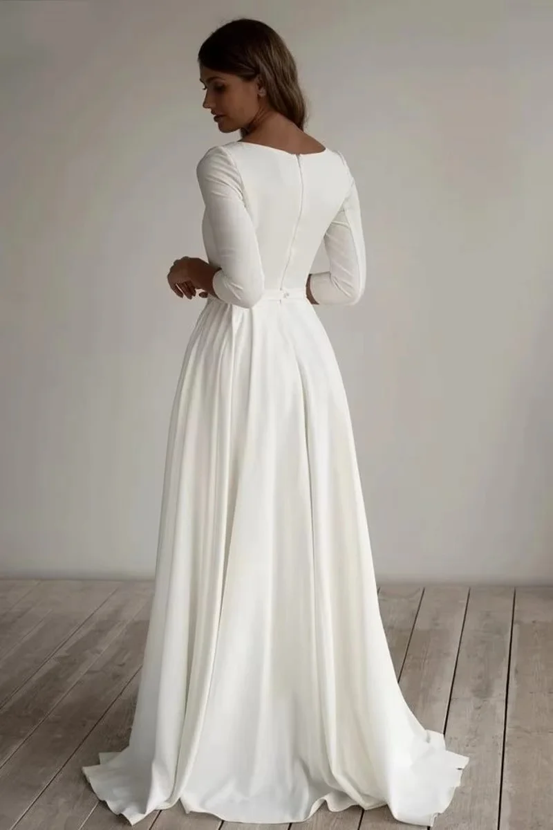 Modest muslim wedding dress with long sleeves, round neck design and flowing A-line train. Multiple colors available, custom-mad