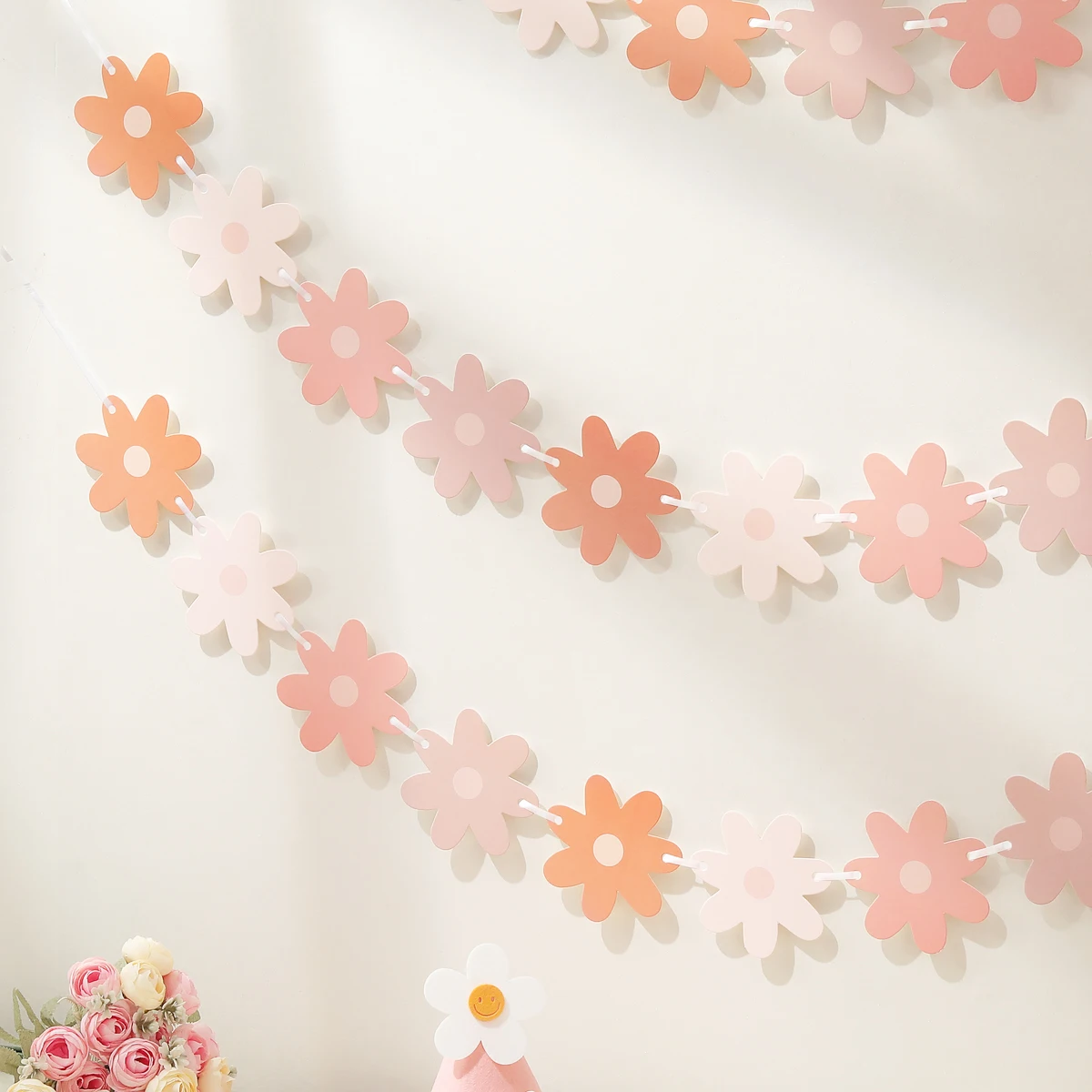 Gradient daisies pull the banner to decorate the holiday party decorations