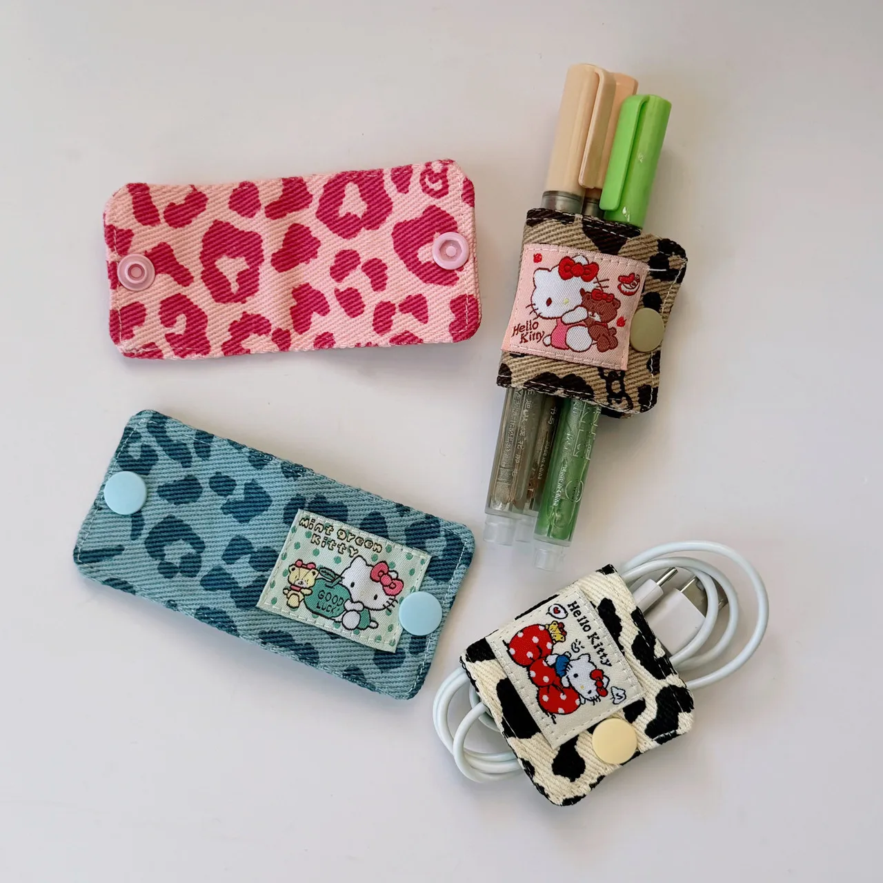 Lindo KT leopardo tela vaquera Cable de datos Clip de almacenamiento hecho a mano Kitty Cable de carga bolsa de almacenamiento cepillo almacenamiento