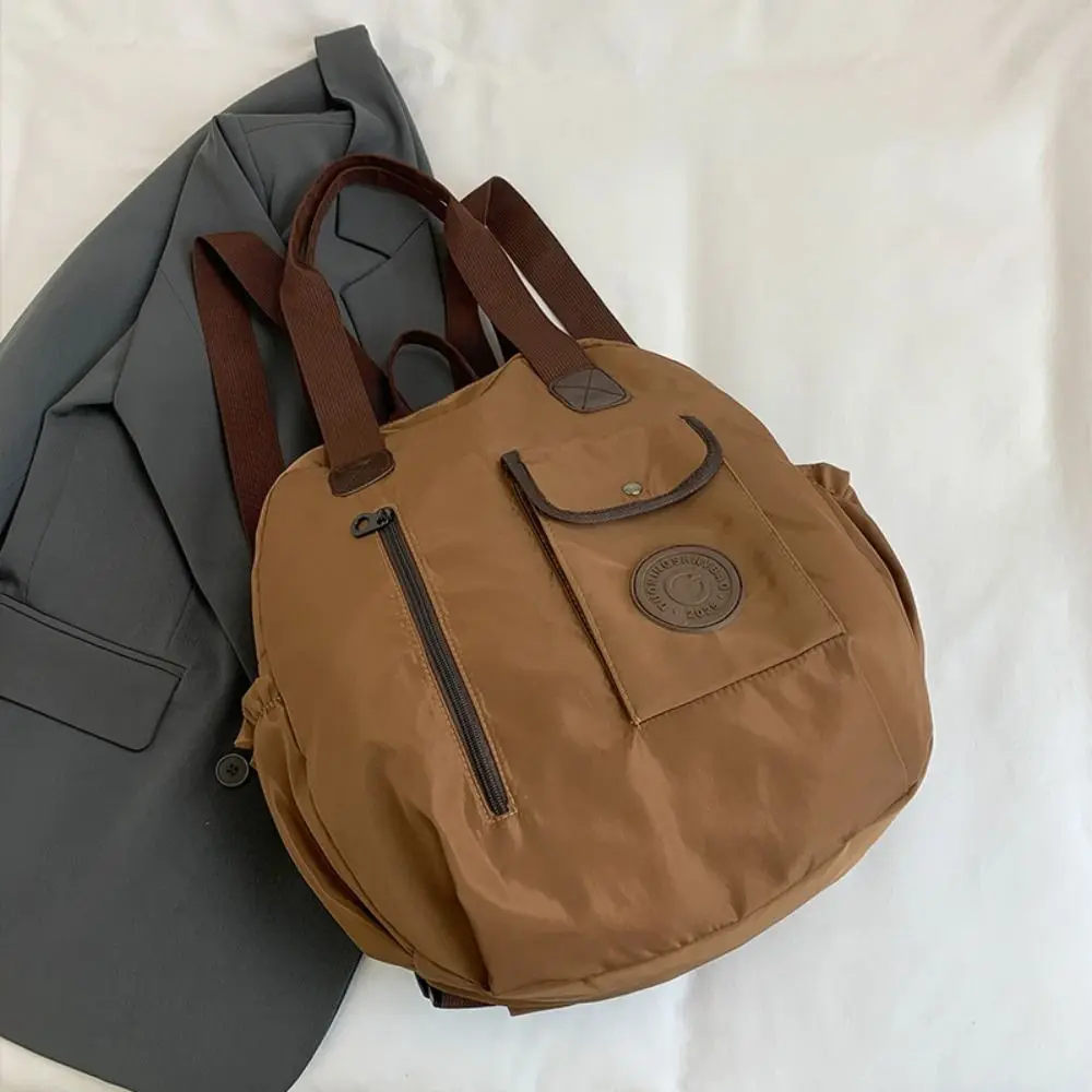 กระเป๋าเป้สะพายหลังไนลอนสไตล์เกาหลีน่ารัก สีพื้น ทรงกลม กระเป๋าสะพายไหล่ กระเป๋าโท้ท ความจุเยอะ เหมาะสำหรับออกกำลังกายและกิจกรรมกลางแจ้ง