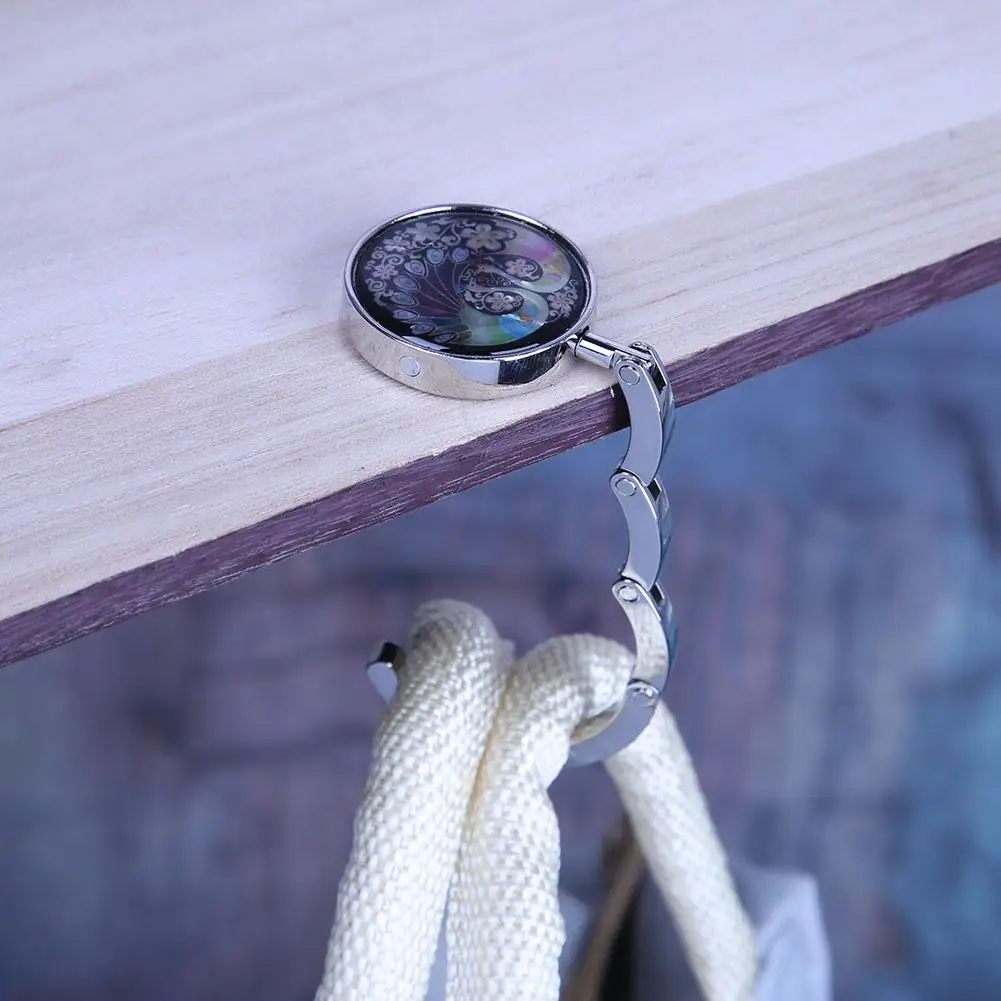 شماعة حقيبة يد قابلة للطي بخطاف محفظة الطاووس لتخزين حقائب اليد على الطاولة