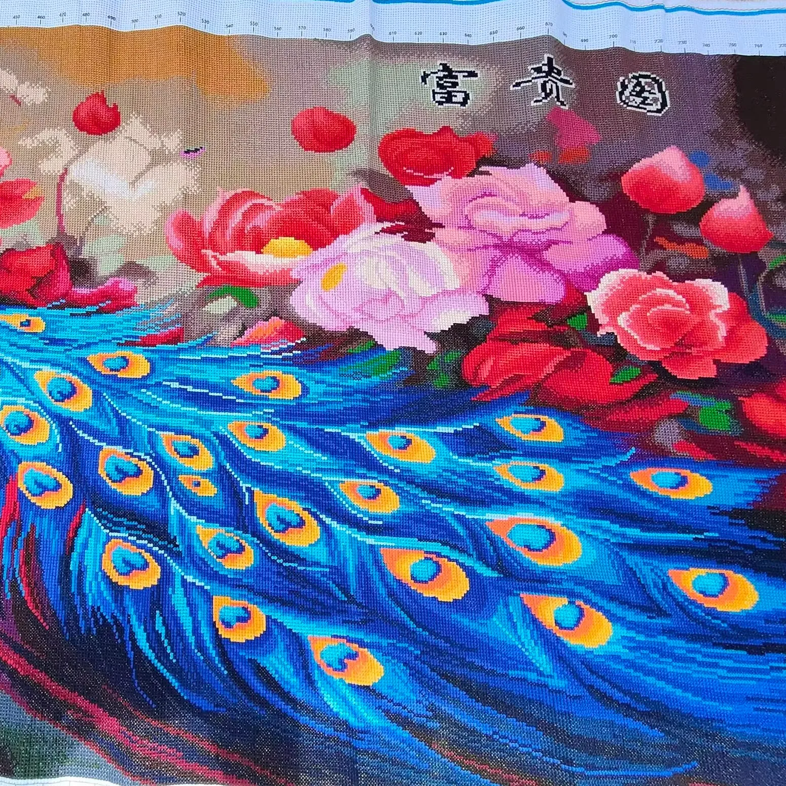 A handmade cross stitch finished product with blooming flowers, luxurious blue peacocks, and peonies. Chinese style living room