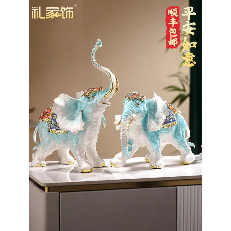 A pair of trumpets, enamel and auspicious elephant ornaments