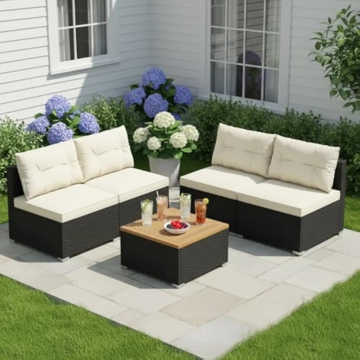 5-piece outdoor rattan lounge set featuring 4 armless sofas with removable off-white cushions and a square acacia wood coffee ta