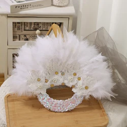 An elegant bridal fan - hand-held, exquisitely handcrafted - the perfect wedding gift