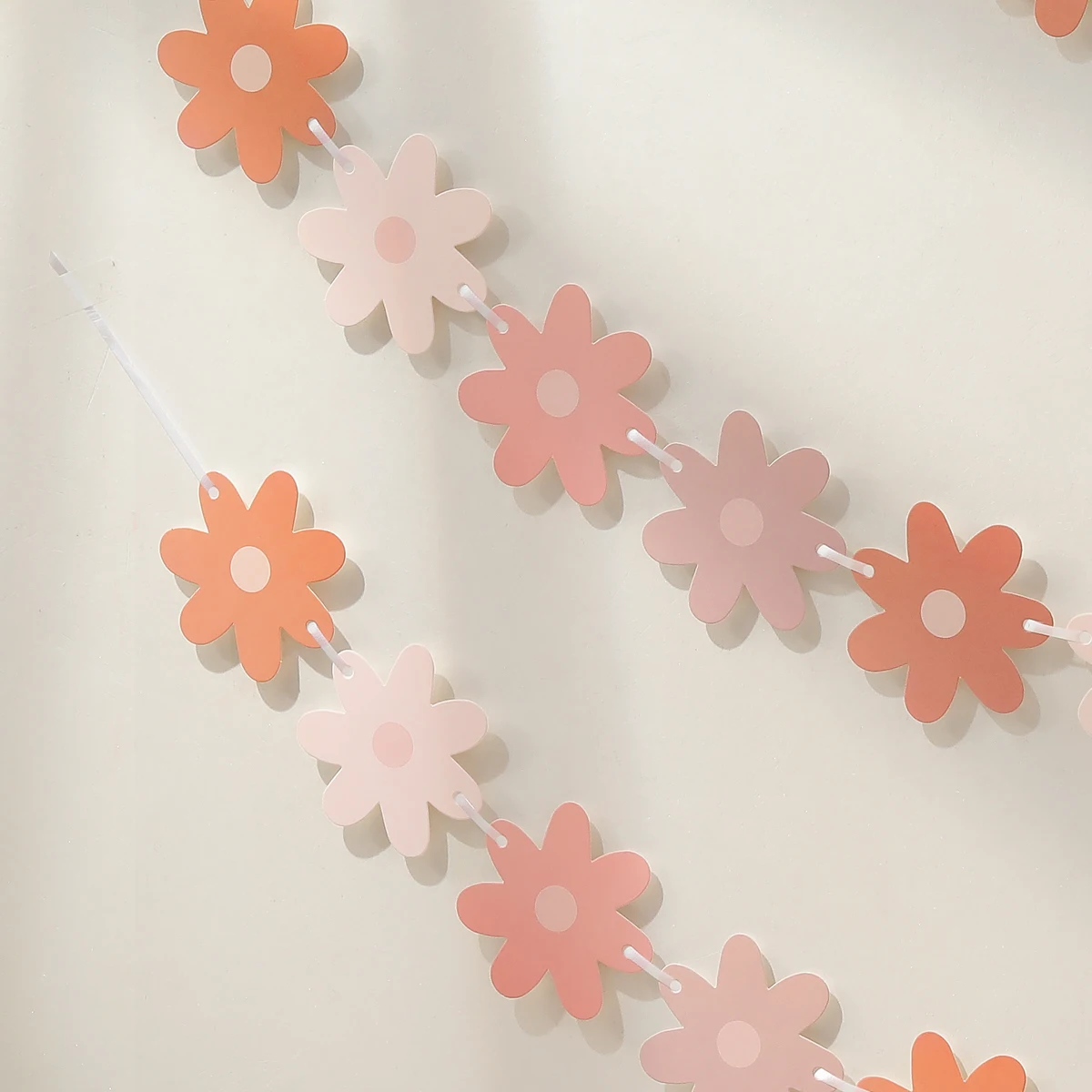 Gradient daisies pull the banner to decorate the holiday party decorations