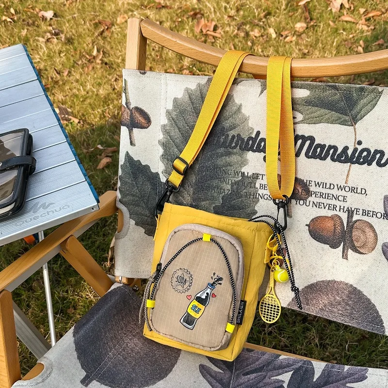 

2026 New Trendy Print Crossbody Bag for Women Lightweight Nylon Shoulder Bag with Mini Racket Pendant Casual Travel Fanny Pack