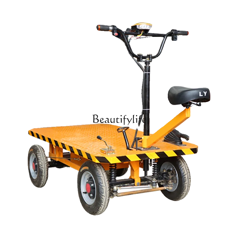 

Electric flatbed truck handling is riding upside down construction site pulling bricks and goods four-wheeled trolley