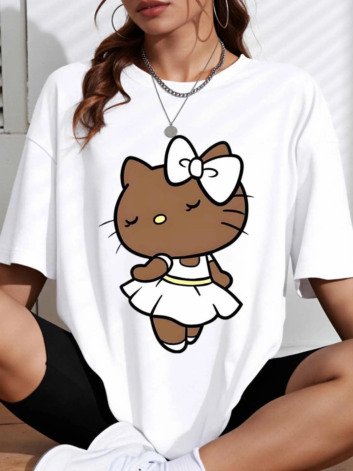 

Sanrio Hello Kitty in a Brown Cute Oversized Tee Featuring a Graphic of Cat Bow Dress, Perfect for Casual Summer Fashion