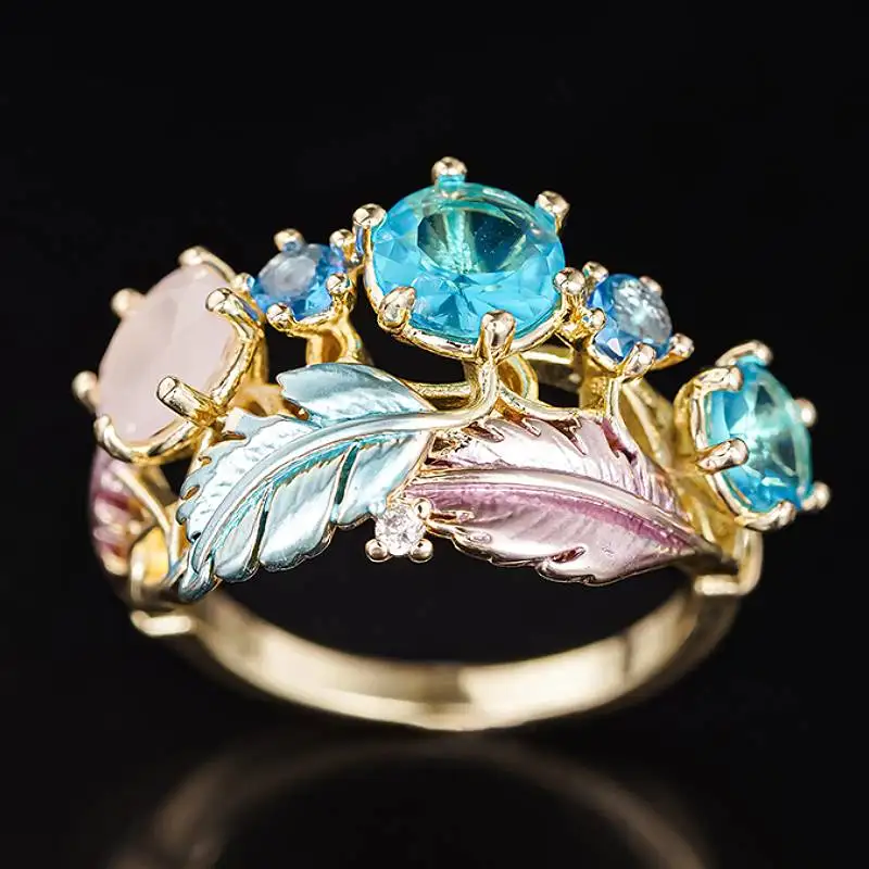 Huitan Feder-Design Damenring in Goldfarbe, Ästhetischer Partyschmuck, Elegantes Accessoire mit Blauen Glitzernden Zirkonia, Trendiger Schmuck für Hochzeiten