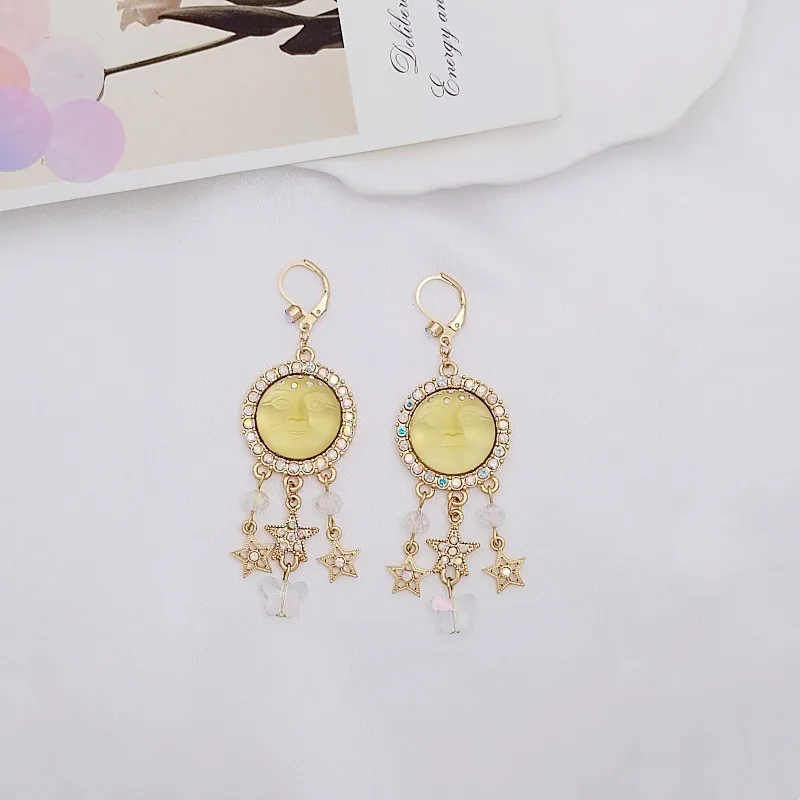 

KF Maon Face Tassel Earrings – Iridescent Star Design for Root Chakra Grounding & Attracting Creative Stability