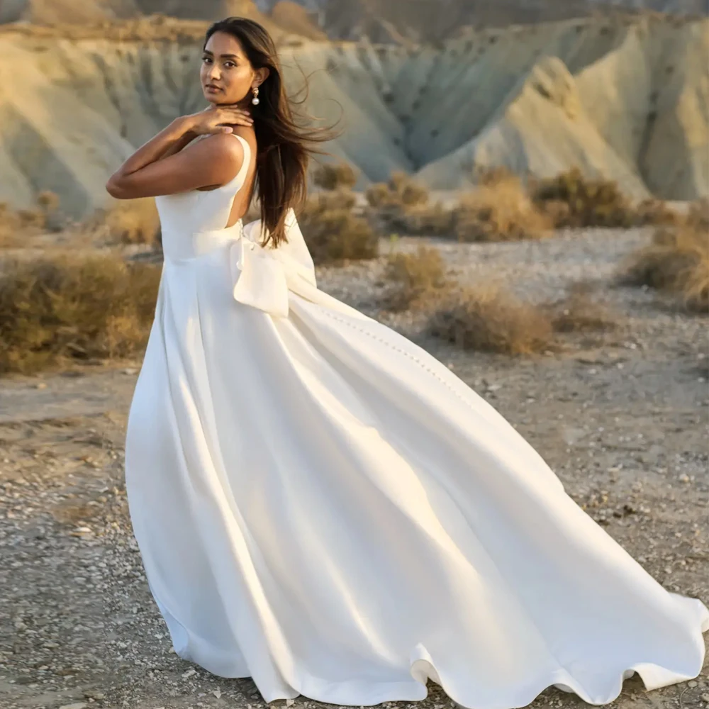 Una linea profondo scollo a V cinturino largo senza maniche abito da sposa in jersey personalizzato abiti da sposa fiocchi aperti sul retro cerniera nuovi abiti da sposa
