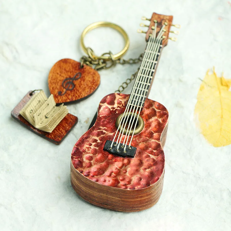 

Handmade folk guitar instrument pick storage box keychain pendant genuine leather handmade sliding cover integrated pick gift
