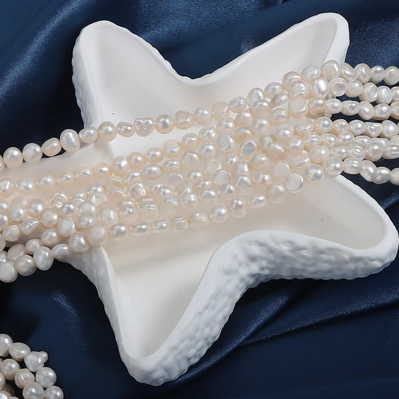A strand of 5-6mm side-drilled, two-sided polished natural freshwater baroque irregular pearls, approximately 36cm in length.