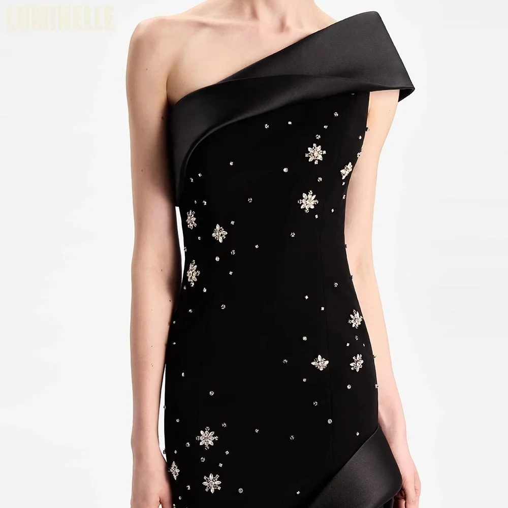

Luxurious black one-shoulder satin gown with elegant mermaid skirt and subtle accents. Fully customizable for a sophisticated mo
