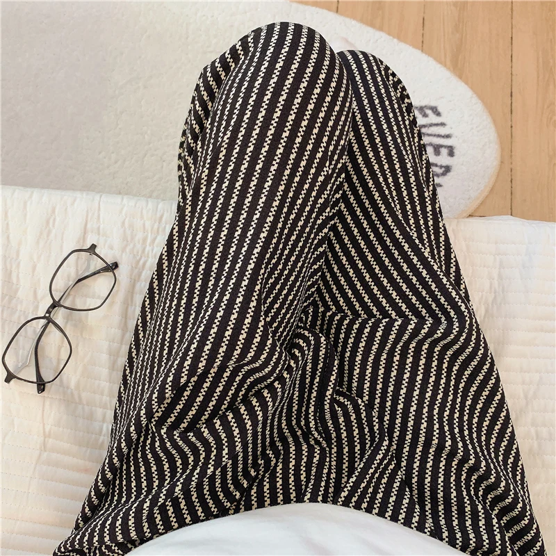 124 black vertical striped trousers