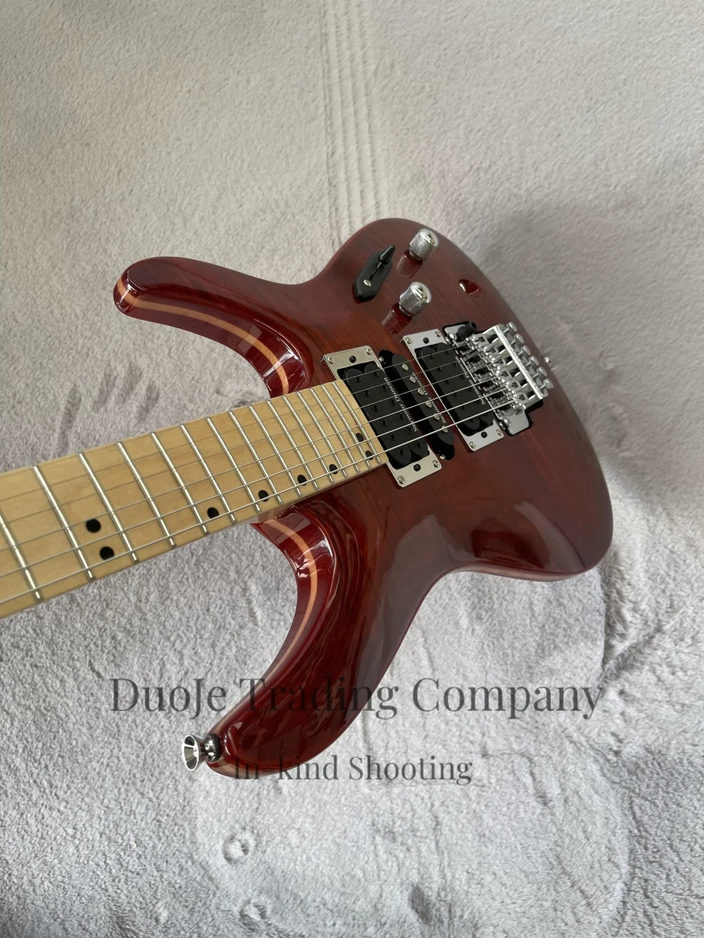 

Brown guitar, thin-body guitar, flamed maple top, tremolo bridge, HSH pickups, solid wood body, maple neck.