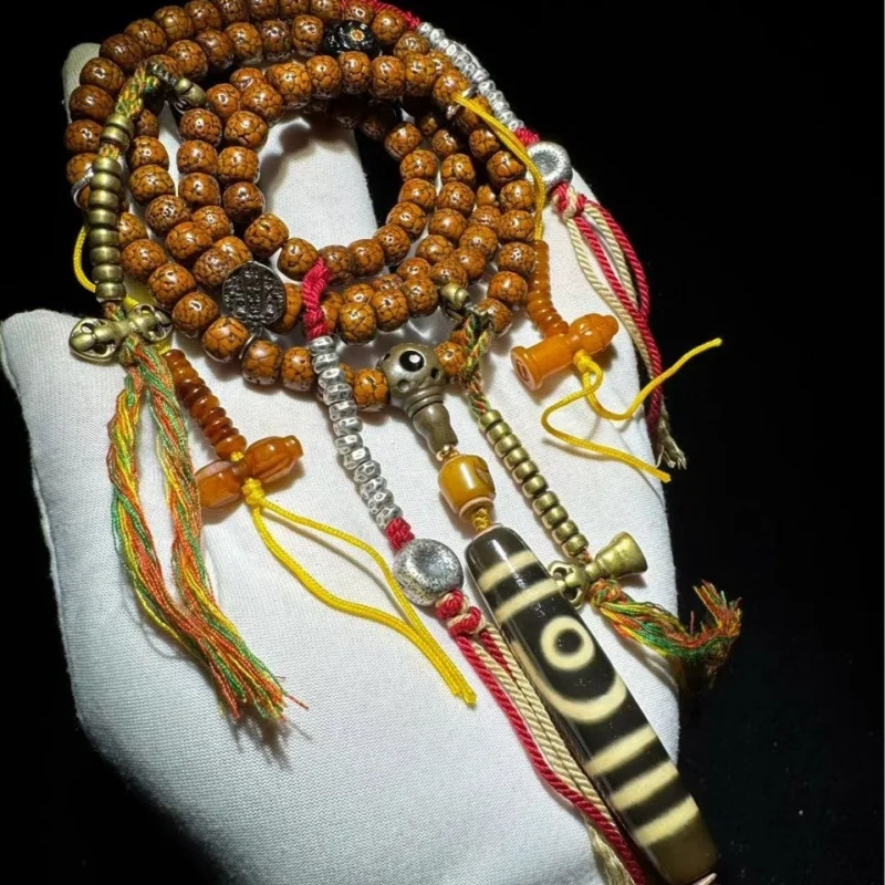 vintage star-moon multi-strand bracelet Tibetan sacred objects and two-eyed dzi beads, with a rich patina