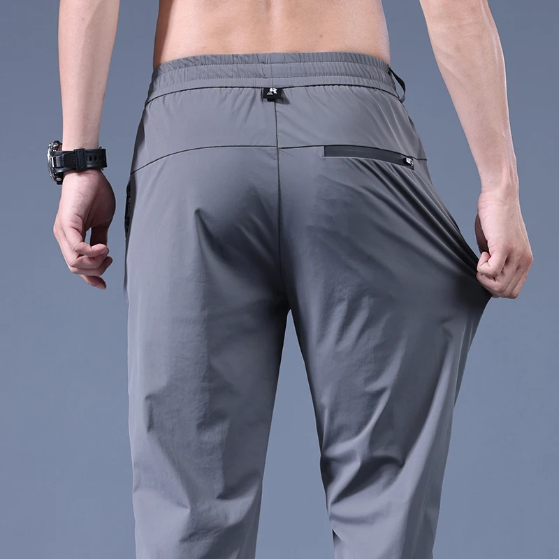 

2023 new hot summer men's fashion casual ice silk pants men's elastic solid color nine points sports pants Ankle banded pants