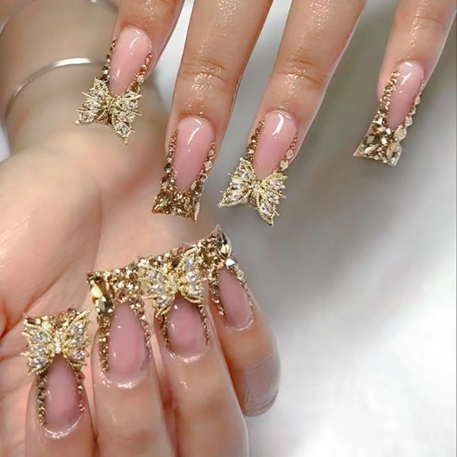 

24Pcs Duck Flare Press On Nails, Nude Pink with Gold French Tips & 3D Rhinestone Butterfly Fake Nails