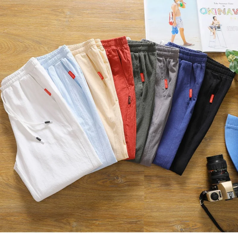 กางเกงขาสั้นผู้ชายผ้าลินินเทียมระบายอากาศดี สไตล์ฮาวาย สำหรับใส่ไปชายหาด สีพื้น ทรงหลวม ใส่ได้หลายโอกาส สไตล์สตรีทแฟชั่น