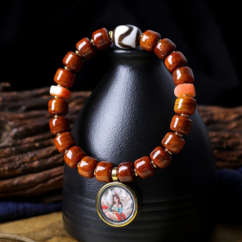 Tibetan- bone tiger-tooth bead bracelet original design featuring a nine-tailed fox and a Tangka-style charm