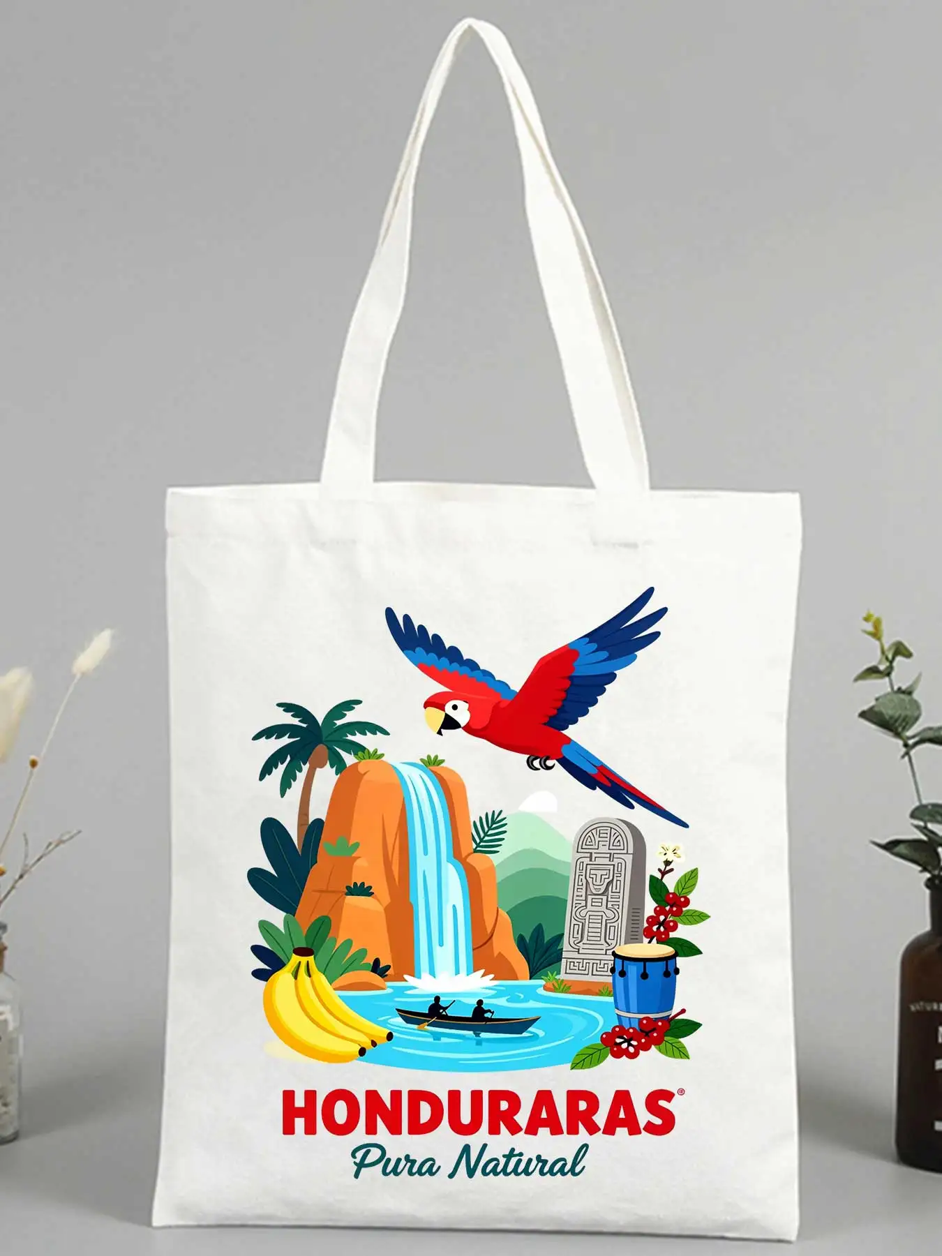 Women's nature graphic canvas tote bag with tropical bird and waterfall print, ideal for casual outings and summer shopping