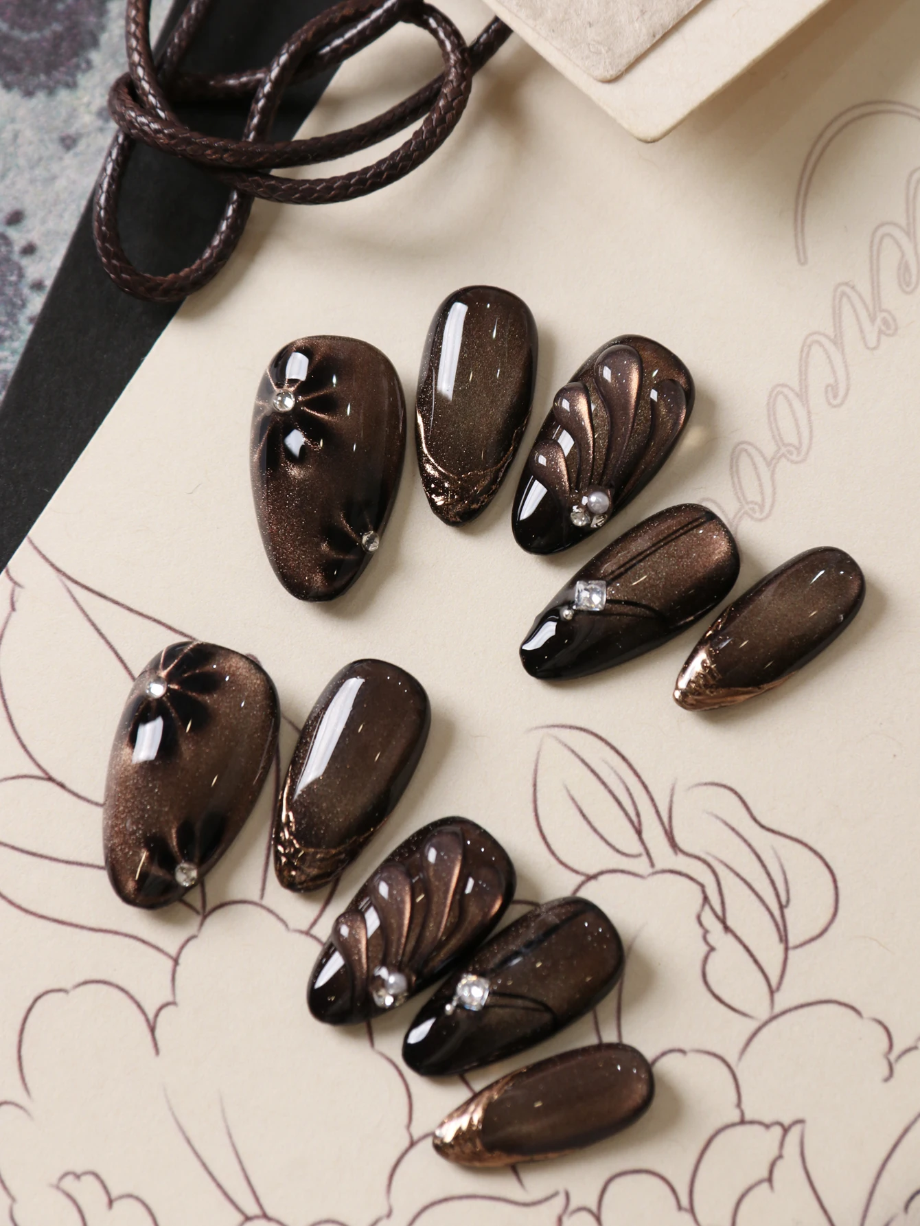 10Pcs Press on Nails Short Black Flowers Brown Cat's Eye Press on Fake Nails Includes 1 Sheet of Adhesive Tabs & 1 Pc Mini File