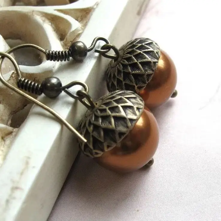 Retro-style double-color acorn-shaped pendant earrings for women, suitable for both casual and professional wear.