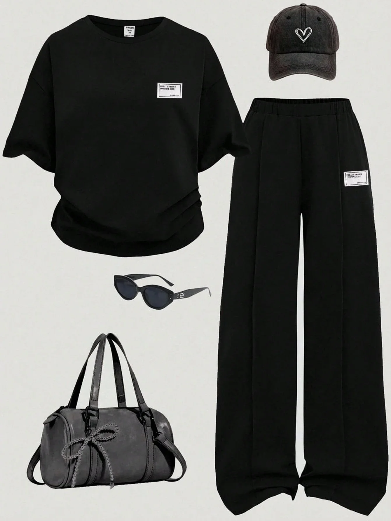 

Черный комплект: футболка с широким вырезом и спущенными плечами, а также широкие брюки-джоггеры, повседневный уличный стиль